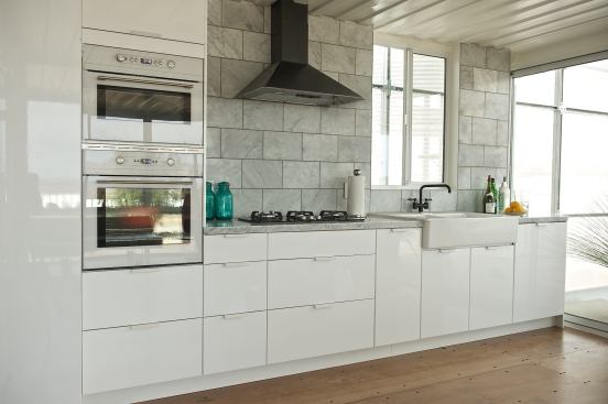 The floor in the  kitchen (and throughout) is made from recycled Philippine mahogany plywood that can be easily sanded down and refinished.