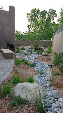 In New Mexico’s arid climate, a stream of rough-hewn stones adds visual interest to this Pueblo-style home’s landscaping. Project: Las Placitas Residence; Architect/Builder: McDowell + Satzinger Fine Homes, Santa Fe, N.M.
