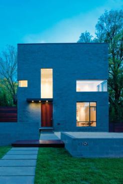 A vertical window extends this home’s entryway, allowing the door to act as a piece of the façade’s play on geometric cutouts. Project: Hampton Lane House, Bethesda, Md.; Architect: Robert M. Gurney, Washington, D.C.; Builder: Freedom First Homes, Bethesda, Md.
