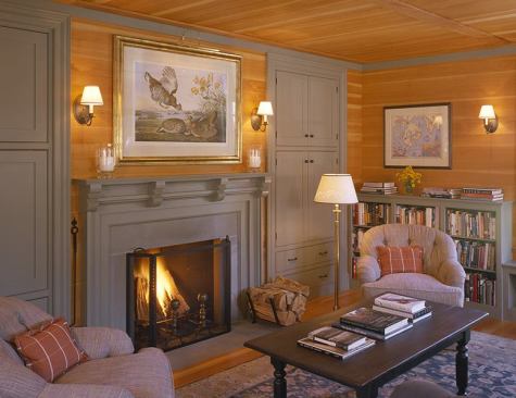 Painted millwork lightens the wood-clad rooms and provides storage for lots and lots of books.