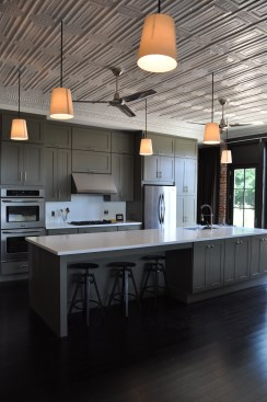 Hanging from the restored ceiling are off-the-shelf floorlamps that were re-rigged as pendants. 