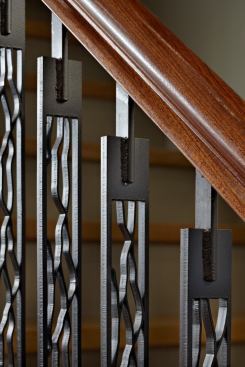 Patterns that Finne develops for furnishings and hardware often find their way into other building elements, such as this stair railing.