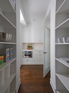 Small appliances and other cooking gadgets can be discreetly stored in the large walk-in pantry.