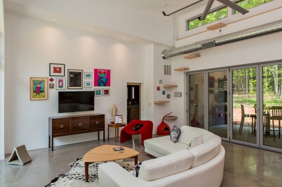 For the cats in the family, the architect devised "cat stairs" in natural wood for one corner of the living area that rise 12 feet up.