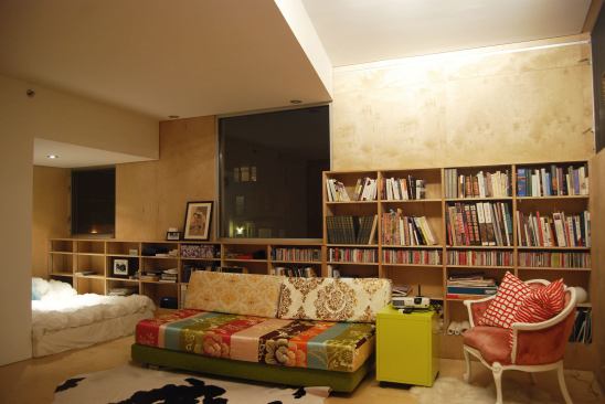 The second-floor guest bedroom has built-in bookshelves and a cozy alcove that can be used for multiple purposes.