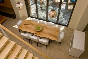 The Smart Home's dining room table is made from a fallen ash tree and finished with a low-VOC finish. The chandelier is made from recycled light bulbs.