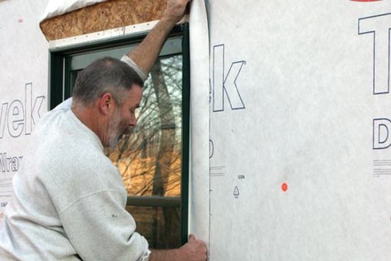 Flash the Jambs and HeadStarting 2 to 3 inches above the window head, I apply flashing membrane over the jamb flanges, letting the tape extend at least to the bottom of the sill flashing.