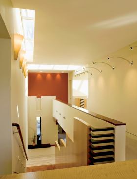 The ebony horizontal slats at the top of the stairs echo the ebony detailing featured in other parts of the house.