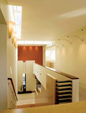 The ebony horizontal slats at the top of the stairs echo the ebony detailing featured in other parts of the house.