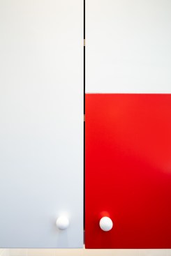 False cut in cabinet door for red finish