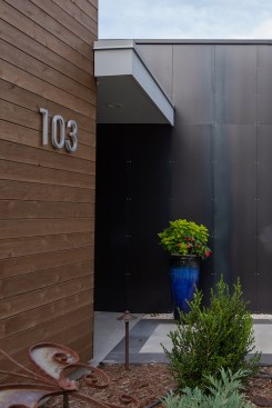 The visually warm natural cedar is juxtaposed with a custom-fabricated steel wall at the main entrance.