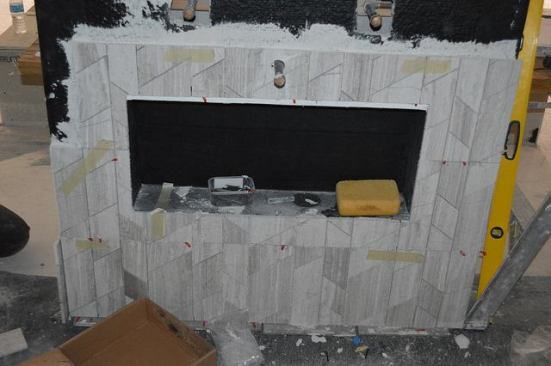 A fireplace surround takes shape.