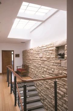 A large skylight illuminates Edge House’s central stair.