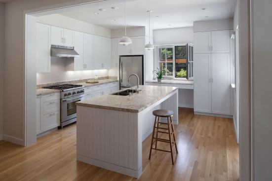 "To stay within budget we avoided expensive interior materials and details in order to include agenerously sized kitchen,” Christensen says of the large, airy kitchen, adding that even the honed granite countertop was economical.
