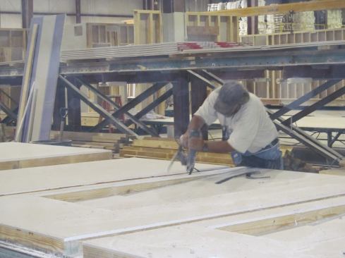 Mod-U-Kraf’s 168,000-square-foot factory in Rocky Mount, Va., includes 18 work stations, including this one where one of the plant’s 72 hourly employees kicks up drywall dust as he cuts openings for doors and windows into a prefabricated wall.