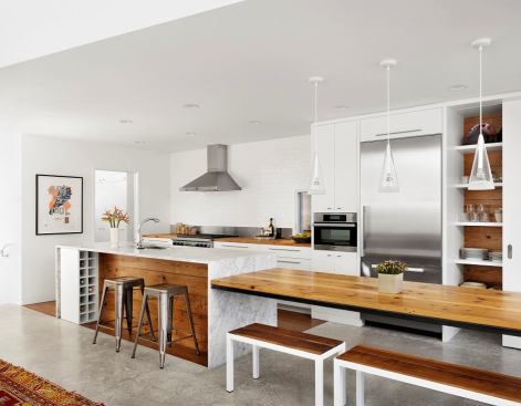 2014 Grand Winner, Custom Kitchen in a House Less than 3,000 sqft: Hillside Residence Kitchen The galley layout is centered around a work island. Long-Leaf pine from the original home's floor joists, was used for the island's dining table and recessed panel, playing against the white marble.