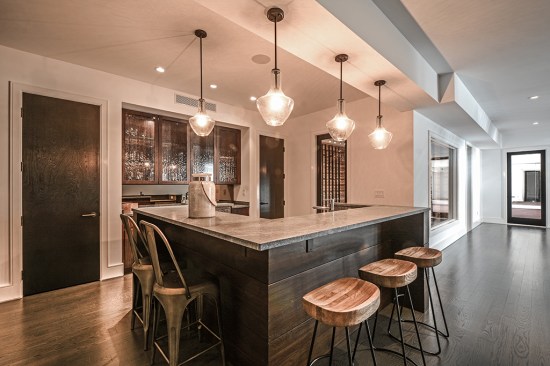 L-shaped bar with custom cabinetry, sink, beverage fridge, ice maker, dishwasher and seating for 5