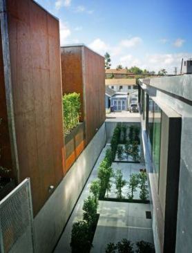 There's a sustainable component, too. Half of the project's electricity needs are derived from rooftop photovoltaic panels. Xeriscaping in an interior courtyard minimizes water usage.