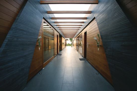 The pods are clad in recycled teak planks and local basalt, or lava rock, which adds thermal mass and helps anchor the structures during tropical storms.