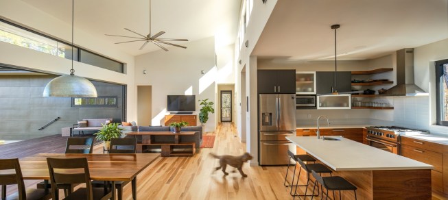 The clear east-west axis extends through the center of the house to the screened porch beyond the glass door at the end of the hall.