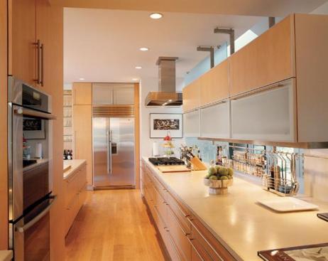 To flood the kitchen with natural light, the architects/owners replaced the back panels of stock cabinets with glass.