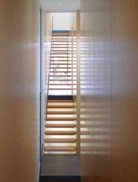 Residential Architect  2010 RADA  Claremont House, Chicago  architectural design detail / merit    Occupying a space that extends from the front of a deep, narrow townhouse-form residence to the rear, this stairwell conveys not only people, but also light, air, and even structural stresses in the building frame.