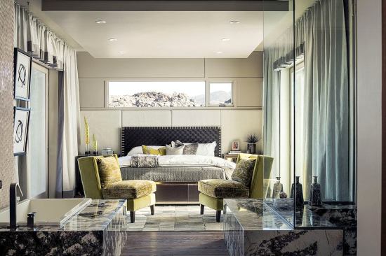 The first-floor master bedroom is a sumptuous retreat for grandparents or guests. For a unique flooring choice, designerse speced the same Thermory thermal-treated hardwood decking used outside.