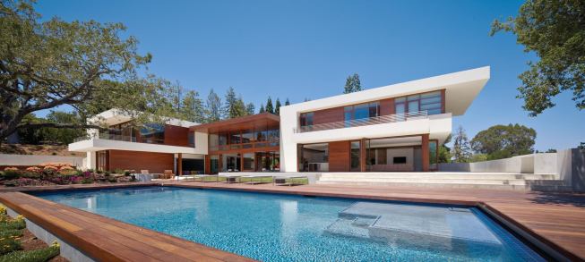 Stucco clads the bedroom wings, distinguishing them from the mahogany-clad central portion.