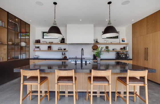 The kitchen has clean sitelines to the stairs up to the space over the garage.
