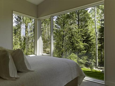 Corner windows bring views of the tranquil site into the bedrooms, making those space feel larger than they actually are.