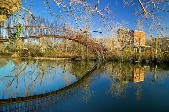 2008 Outdoor Spaces' Winners
2008 Grand Award -
Austin, Texas, Pedestrian Bridge
Entrant/Architect: Miró Rivera Architects, Austin, Texas;
Builder: Signor Enterprises, Austin Built to connect the main house to the guesthouse (shown), this footbridge makes a poetic leap across an 80-foot-wide lagoon.