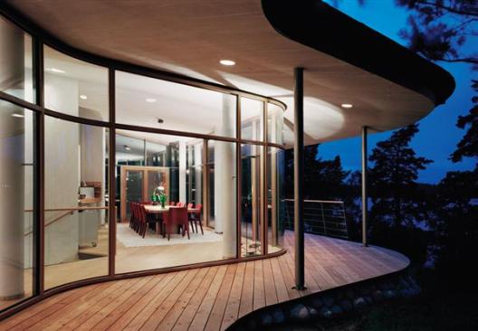 Pale colors, ample glazing, and an open plan generate bright, airy spaces that mitigate the rocky terrain and rough weather outside.