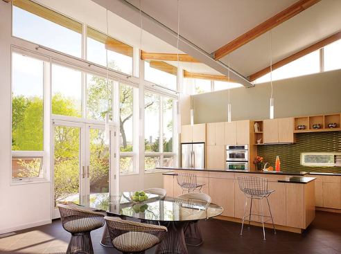 Architect: 
Farr Associates, Chicago; 
Builder: 
Goldberg General Contracting, Chicago. The beams extend beyond the transparent walls of the airy space to support a wood-clad overhang that shades the glass. 
Read more about the builder of this house and see more iamges of the project here.