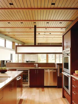 A bar-height backsplash helps conceal cooking operations from the adjacent dining area. 