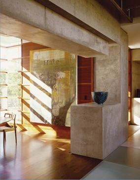 Poured concrete forms a subtle, sculptural display space for the clients' ceramics collection.