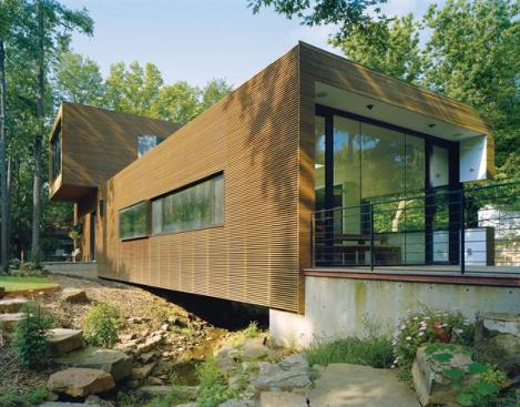The first floor of Marlon and Meryati Blackwells own house sits atop concrete piers, the better to span a creek on the property. 