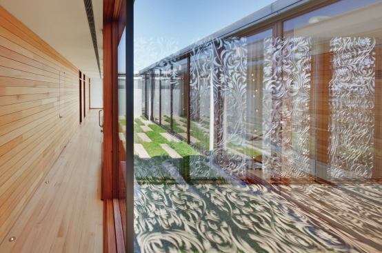 Upstairs, the screens flank an open garden in the guest hall.