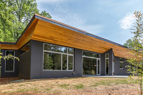 The exterior walls are prefab concrete sandwich panels with built-in insulation made to Schechter’s specifications and brought to the site. The cypress soffit is a soft counterpoint to the concrete cladding and shields the interior from the high summer sun.