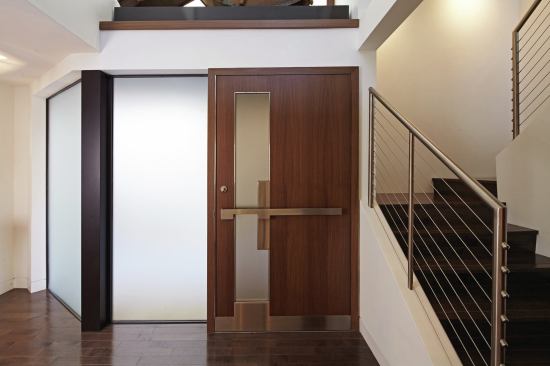 The entry door is a custom piece designed by the architects.