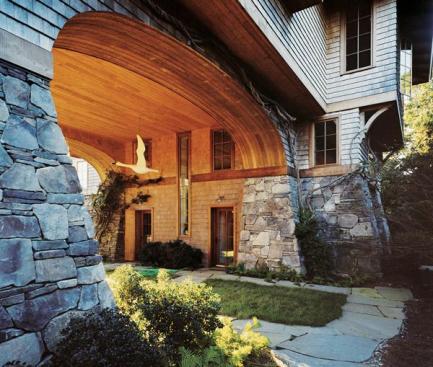 Located in a coastal flood plain, the building concentrates habitable square footage at its upper floors. Leftover space at the lower levels is devoted to a picturesque tunnel.