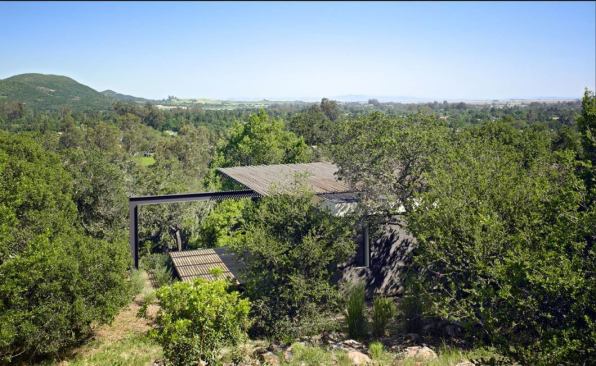 The meditation pavilion sits below the house and is anchored to its south-facing slope with piers and grade beams to preserve as much vegetation as possible.