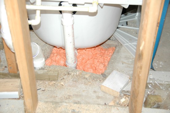 Holes in the slab that accommodate plumbing should also be filled and sealed.