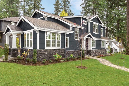 new luxury home with elegant touches including covered entrance, columns