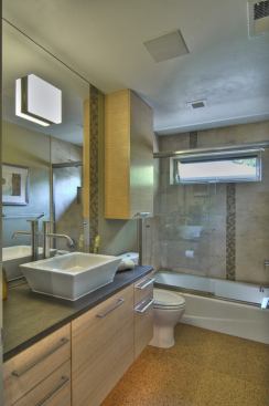 In addition to low-flow fixtures, the bathrooms feature cork flooring from Sustainable Flooring and PaperStone countertops, which are crafted from post-consumer waste and petroleum-free resins. 