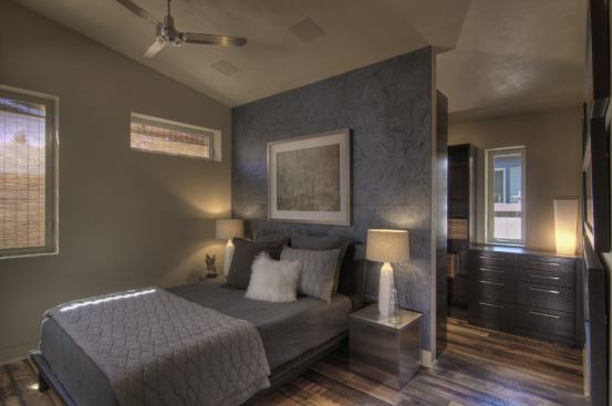 Pioneer Millworks reclaimed flooring brings a one-of-a-kind look to the bedrooms and the rest of the house. Creative placement of an interior wall sections off storage.