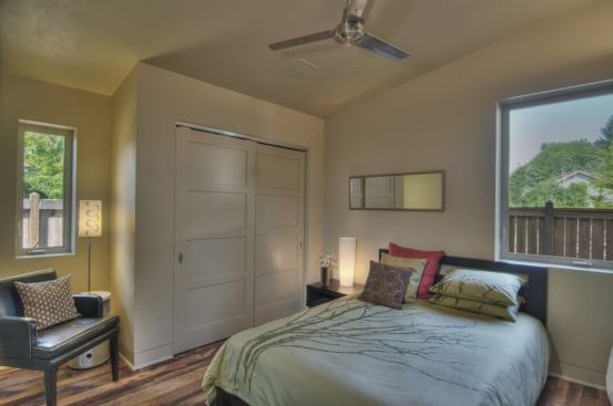 Windows on two sides of the bedroom bring natural light while making the room feel larger.