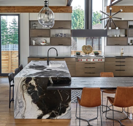 The U-shaped second-floor gallery overlooks the grand living-dining space on the main floor.