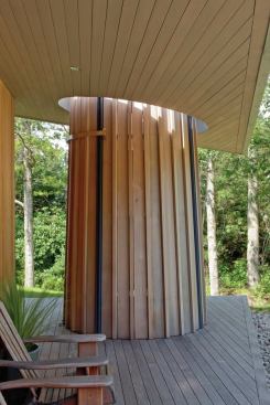 
        The design team wanted the shower to 
read as the strongest part of the porch composition, so they produced a 
circular opening in the porch overhang so the shower stands as an 
uninterrupted form.