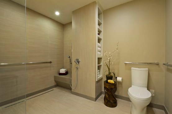 The curbless shower is made with slip-resistant tile.The ADA toilet is pre-plumbed for bidet, and includes grab bars.  
