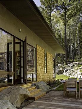 The guest house uses cross-ventilation, solar orientation, and overhangs as additional passive cooling strategies.